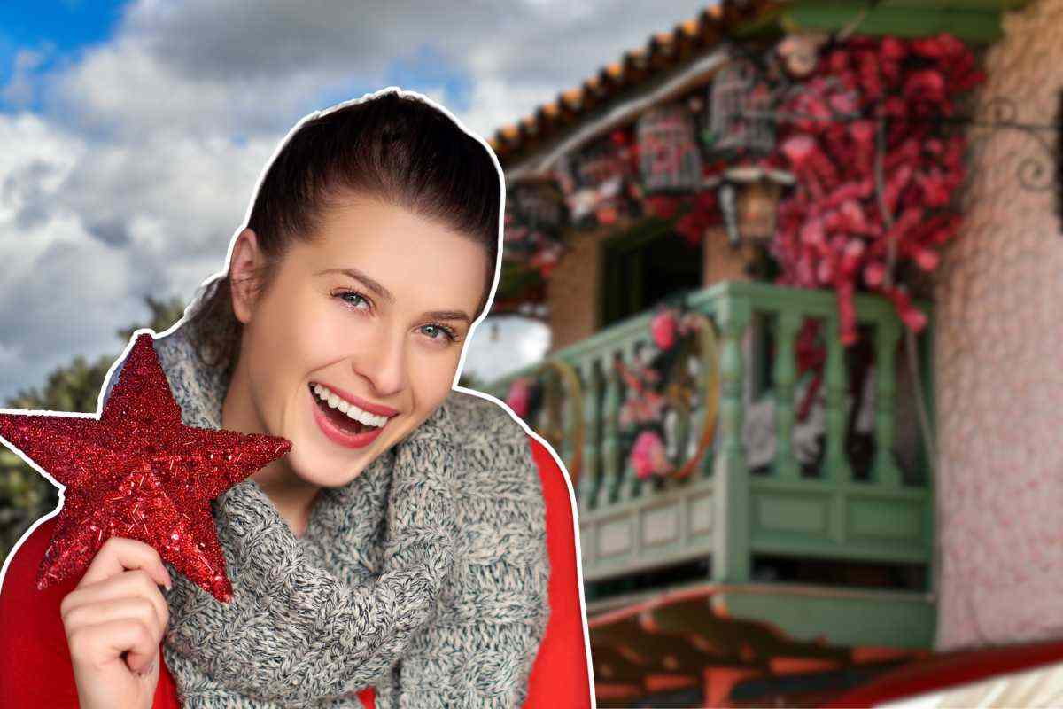 ragazza con una stella di natale in mano e balcone di casa sullo sfondo